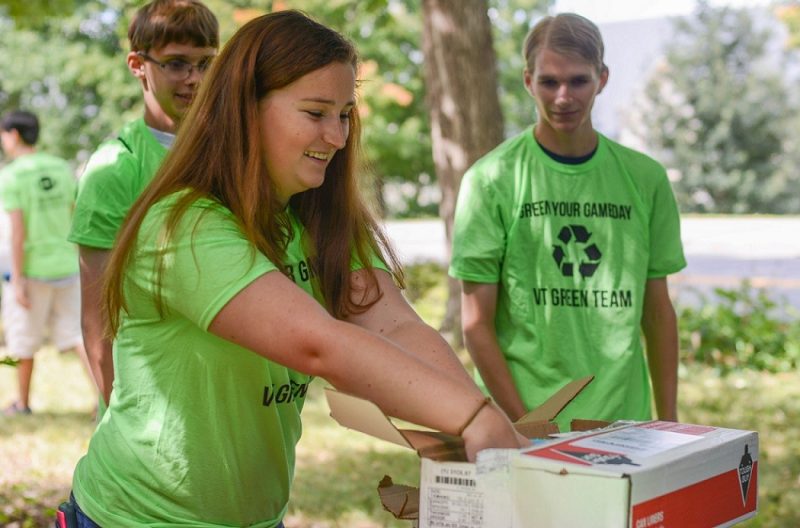 The Office of Sustainability's student-led Green Team collects bottles and cans from game day tailgates and hands out blue recycling bags. THE Impact Rankings for 2021 recognize Virginia Tech's sustainability efforts.