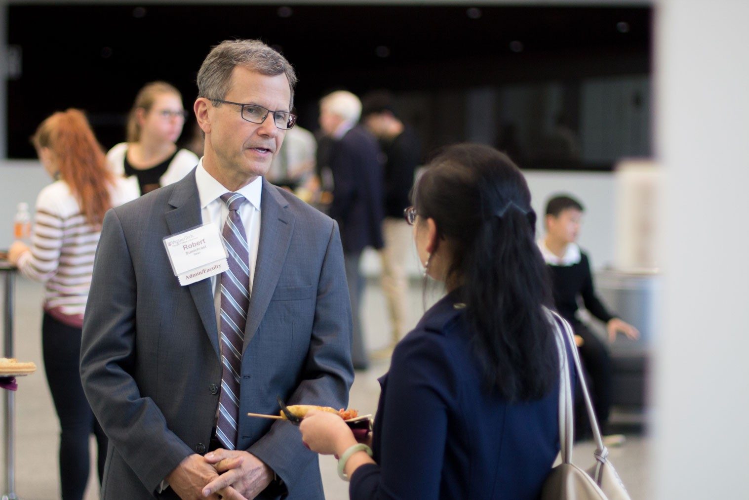 Dean Robert Sumichrast interacts with attendees at the international student reception