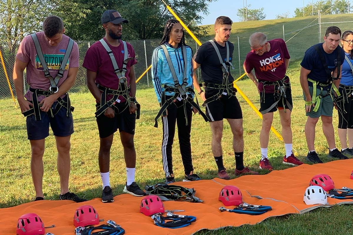 Participants receive instructions about harness installation. From left - Austing Wallace, Misganaw Mengiste, Kaela Kinder, Jordon Erisman, Jay Winkeler (executive director, Center for Business and Analytics), Jackson Wellons, Manal Zorigtbaatar. (Photo credit: Adrienne Sable)