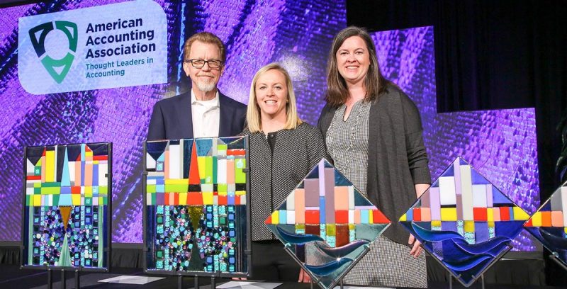 Sarah Stein (center) and Lauren Cunningham receive their Best Paper Award from presenter Mark DeFond at the 2019 American Accounting Association annual meeting. (Photo credit: American Accounting Association)