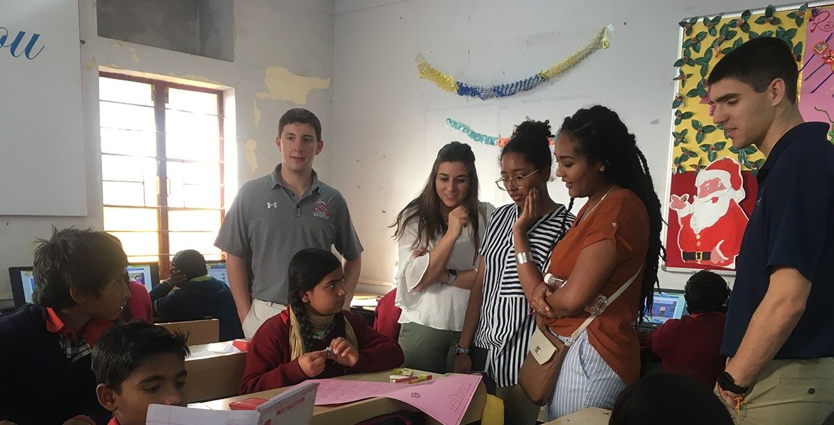 Visiting a school in India, where the children learn how to fix cell phones and computers. Left to right: Ethan Williams, Katie Pearson, Cat Piper, Gelila Reta, Nick Clark. (Photos courtesy of Reed Kennedy)