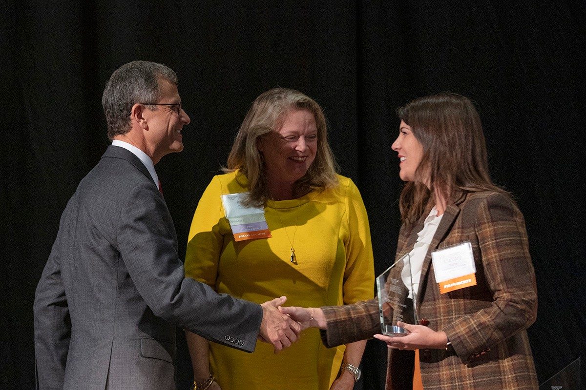 Dean Robert Sumichrast and Kelly Pickerel (FIN ’82) congratulate Mallory Tuttle (M.S., HTM ’14), who received an Ut Prosim Award from the college. (Photo credit: Brett Lemon)
