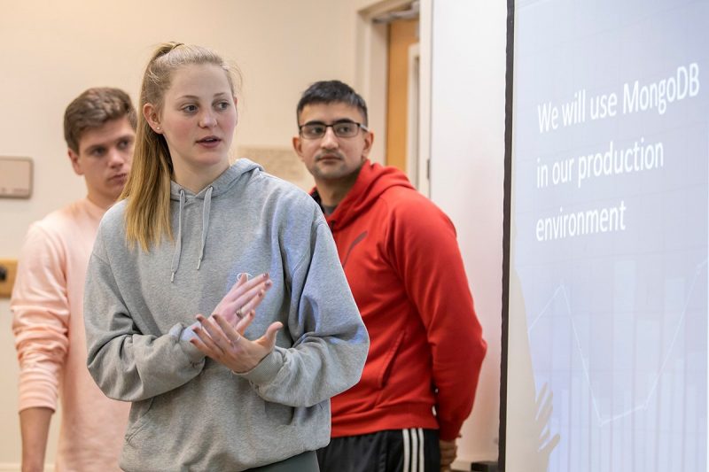 Presenting their Singapore Management University project roadmap during a class presentation in February 2020, from left: Andrew Barstow, Hannah Vaas, Grigori Martirosyan. (Photo credit: Shawn Sprouse)