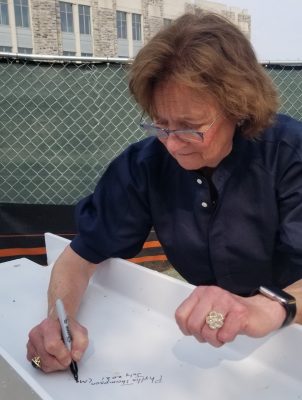 Phyllis Thompson M.S. ’73 signs a beam that will be placed in the Data and Decision Sciences Building.