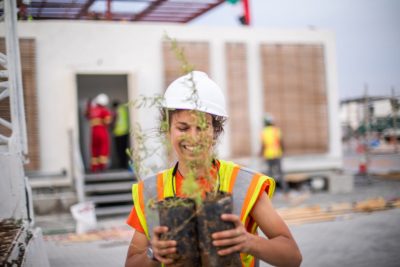 Alexandra Schiavoni, a landscape architecture master's student from Boiling Springs, Pennsylvania, moves plants from a truck to the construction site.