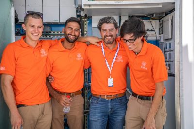 Left to right: Philip Kistler, Kunal Gandhi, Carlos Tarabillo (recently-graduated electrical engineering student from Santa Cruz, Bolivia), and Matt Erwin (recently-graduated electrical engineering student from Chesapeake, Virginia) in front of the house's mechanical room.