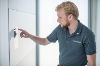 Electrical engineering student Matt Tucker of Knoxville, Tennessee, uses one of the home's touch screen panels to adjust settings in the house.