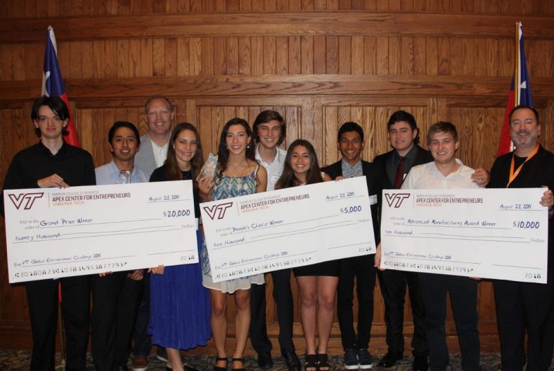 The winning teams from Chile pose with their checks. Derick Maggard, executive director of the Apex Center for Entrepreneurs, is third from left.