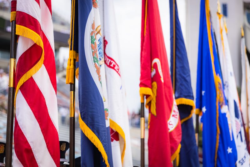 military branch flags in a row with the american flag