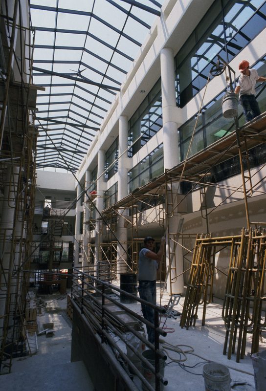 Two construction workers constructing the Pamplin atrium in 1980