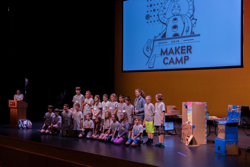 Campers pose for a portrait on stage of the Anne and Ellen Fife Theatre in Moss Arts Center.