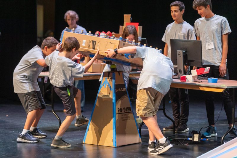 ICAT Maker Camp students assemble their arcade game, Tilty Board, for a live demonstration.